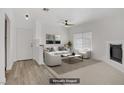 Bright living room with a ceiling fan, modern furniture, and a decorative fireplace at 5112 Harvest Time St # 201, Las Vegas, NV 89130