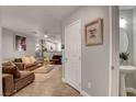 Inviting living room with plush seating, stylish decor, and wood-look tile flooring at 554 Haunts Walk Ave, Las Vegas, NV 89178
