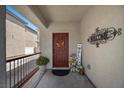 Welcoming front porch featuring a decorative wreath, 'WELCOME' sign, and potted plants, creating a warm and inviting entry at 5656 Fast Payout Ct, Las Vegas, NV 89122