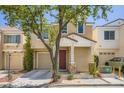 Charming two-story home featuring a well-maintained yard, covered porch, and attached garage at 6125 Broken Slate Way, Las Vegas, NV 89139