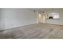 Living room features neutral walls, carpet, and arched entry to kitchen at 6160 Rumrill St # 202, Las Vegas, NV 89113
