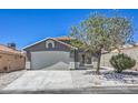 Charming home exterior featuring a well-maintained lawn and a spacious two-car garage at 6456 First View Ave, Las Vegas, NV 89142
