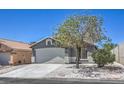 Inviting home with a two-car garage, mature tree, and low-maintenance gravel landscaping at 6456 First View Ave, Las Vegas, NV 89142