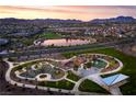 Beautiful aerial view of community park with walking trails, playground, lake and mountain views at 851 Klamath Springs St, Henderson, NV 89011