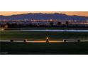 Beautiful lake view with benches, grass and city lights in the background at night at 851 Klamath Springs St, Henderson, NV 89011