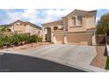 Elegant two-story home with a spacious driveway and a three-car garage in a well-maintained landscape at 8605 Trianon Ln, Las Vegas, NV 89145