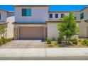 Inviting two-story home with a well-maintained front yard and a spacious garage at 9440 Lunar Ray St, Las Vegas, NV 89143