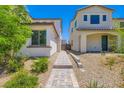 Paver walkway between two homes, lined with gravel and landscaping at 9440 Lunar Ray St, Las Vegas, NV 89143