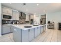 Stylish kitchen featuring a large island, modern appliances, and sleek gray cabinetry at 9440 Lunar Ray St, Las Vegas, NV 89143