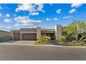 Attractive one-story home featuring a three-car garage, stone accents, desert landscaping and inviting curb appeal at 9972 Terrastone Dr, Las Vegas, NV 89148