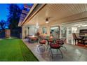 Relaxing covered patio with outdoor seating, a fire pit, and access to the backyard at 10621 Tinta Ln, Las Vegas, NV 89144