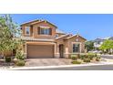 Charming two-story home featuring a large two-car garage, tidy landscaping, and cozy curb appeal at 10961 Winter Rise St, Las Vegas, NV 89141