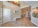 Spacious foyer with high ceilings, tile flooring, and elegant decor at 1145 Glacier Park Ct, Henderson, NV 89052