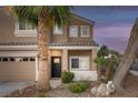 Inviting home exterior showcasing manicured landscaping, a cozy porch, and a two-car garage at 1246 Diamond Valley St, Henderson, NV 89052