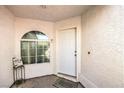 Cozy front porch featuring a decorative window and a neutral-colored entrance door at 2109 Mountain Sunset Ave, North Las Vegas, NV 89031