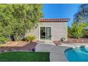 Pool house with sliding glass doors and desert landscaping near the pool at 2150 Maple Heights Ct, Henderson, NV 89052