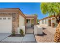 Welcoming home featuring a gated front entrance, stone accents, and a covered entryway at 2508 Chasma Dr, Henderson, NV 89044