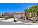 Single-story home with desert landscaping and a stone facade, complemented by a spacious two-car garage at 2508 Chasma Dr, Henderson, NV 89044