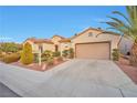 Well-maintained single-story home with a two-car garage and mature landscaping at 2585 Portsmouth Creek Ave, Henderson, NV 89052