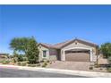 Attractive single-story home with a desert landscape, paver driveway, and a two car garage at 326 Zenith Crest St, Henderson, NV 89015