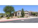 Well-maintained single-story home with desert landscaping, paver driveway, and a lovely exterior at 326 Zenith Crest St, Henderson, NV 89015