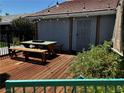 Cozy backyard deck with picnic table, benches, string lights, and privacy fencing at 3601 Slapton Ave, North Las Vegas, NV 89031
