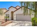 Charming single-story home featuring a two-car garage and desert landscaping at 3609 Blue Pimpernel Ave, North Las Vegas, NV 89081
