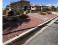 Street view of home featuring desert landscaping with brick walkway at 5005 Wild Thyme Ave, Las Vegas, NV 89131