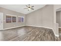Bright living room with a ceiling fan and wood-look flooring at 531 Coolidge Ave, Henderson, NV 89015