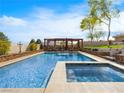 Sparkling pool and spa with a covered seating area, perfect for outdoor relaxation at 5340 N Campbell Rd, Las Vegas, NV 89149