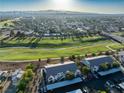 An aerial view of the condo community and golf course with mountain views in the distance on a sunny day at 5655 E Sahara Ave # 1053, Las Vegas, NV 89142