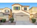 Charming two-story home with a two-car garage, neutral paint, and low-maintenance landscaping at 6460 Raven Hall St, North Las Vegas, NV 89084
