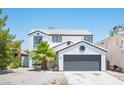 Beautiful two-story home with a well-maintained front yard, garage, and inviting curb appeal at 6524 Rain Forest Dr, Las Vegas, NV 89108