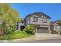 Charming home featuring a two car garage and meticulously maintained landscaped front yard at 68 Vista Del Mar St, Henderson, NV 89012