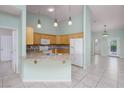 Open kitchen featuring wood cabinets, granite countertops, and tile flooring at 693 Hagens Aly, Mesquite, NV 89027
