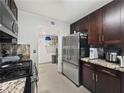 Kitchen showcasing stainless steel refrigerator, tile flooring, and pantry at 7952 Lonette Ave, Las Vegas, NV 89147