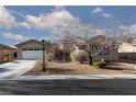 Inviting single-story home showcases a well-kept front yard, creating great curb appeal at 8213 Cabin Springs Ave, Las Vegas, NV 89131