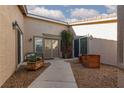 Welcoming front courtyard with decorative planters, seating, and double-door entry at 8213 Cabin Springs Ave, Las Vegas, NV 89131
