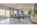 Spacious living room with tile floor, a large sofa, backyard access and modern decor at 9968 Scarlet Hills St # 183, Las Vegas, NV 89141