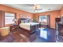 Spacious main bedroom with dark hardwood floors, windows and complementary furniture at , Las Vegas, NV 89122