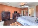Comfortable main bedroom featuring dark hardwood floors and a large dresser with television on top at , Las Vegas, NV 89122