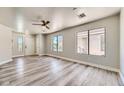 Bright living room with luxury vinyl flooring and natural light from large windows at 1038 Silver Creek Ave, Las Vegas, NV 89183