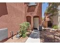 Inviting front entrance with a well-lit walkway and manicured greenery leading to the front door at 10918 Avenzano St, Las Vegas, NV 89141