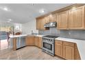 Well-equipped kitchen featuring stainless steel appliances, custom cabinets and quartz countertops at 10955 Sospel Pl, Las Vegas, NV 89141