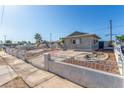 Exterior of single story home with desert landscape and cinderblock and wrought iron fence at 1108 Princess Katy Ave, Las Vegas, NV 89119