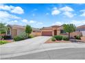 Landscaped front yard featuring a spacious driveway leading to a charming home with a tile roof at 11139 Zarod Rd, Las Vegas, NV 89135