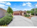 Beautiful one-story home with a tile roof, well-maintained landscaping, and a long driveway at 11139 Zarod Rd, Las Vegas, NV 89135