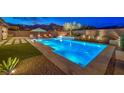 Inviting pool area with a modern pool, sleek patio, and lush landscaping at 12544 Claymore Highland Ave, Las Vegas, NV 89138