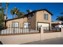 This home features a well-maintained front yard, secured by an ornate iron fence, offering both security and curb appeal at 1340 Lucky St, Las Vegas, NV 89104