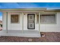 Welcoming front porch with decorative window bars adding charm to the home's entrance at 1608 June Ave, North Las Vegas, NV 89032
